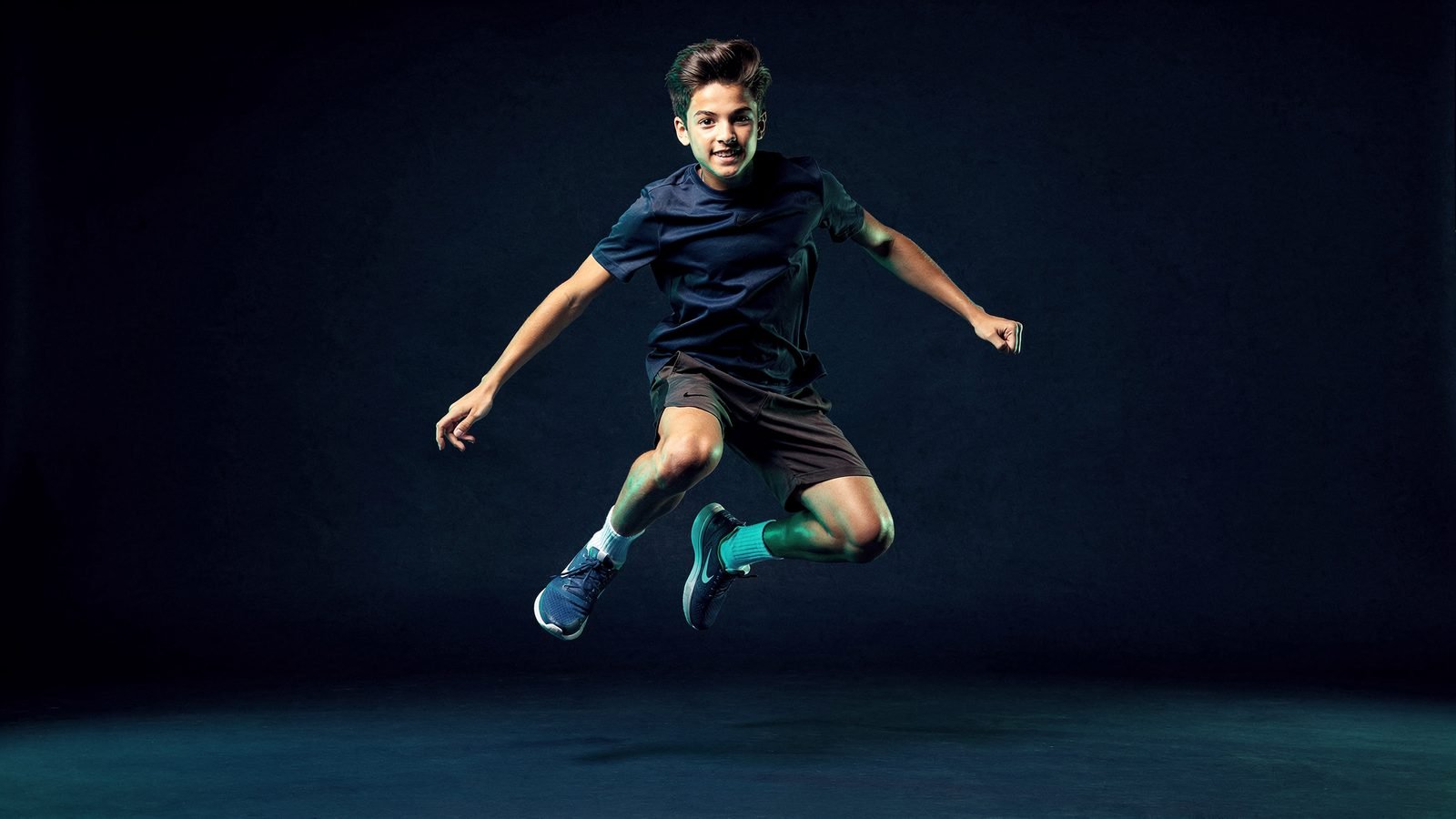 A student mid-jump during a PE lesson